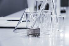 images of glass chemistry beakers in a lab