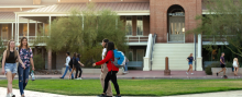 students walk on paths in front of Old Main