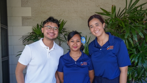 Javier Aguiniga with the WEST EJ Center poses with two employees of the Hawai'i Public Health Institute at a community outreach event. 