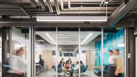 A group of people sitting together in a study room.