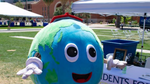 "Big Eartha" at the Students for Sustainability Earth Week 2022 Environmental Summit greeting the attendees near the tables