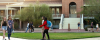 students walk on paths in front of Old Main